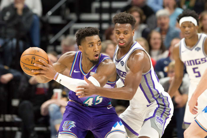 Donovan Mitchell (45) survey's the floor against Buddy Hield (24) as De'Aaron Fox (5) lurks in the background